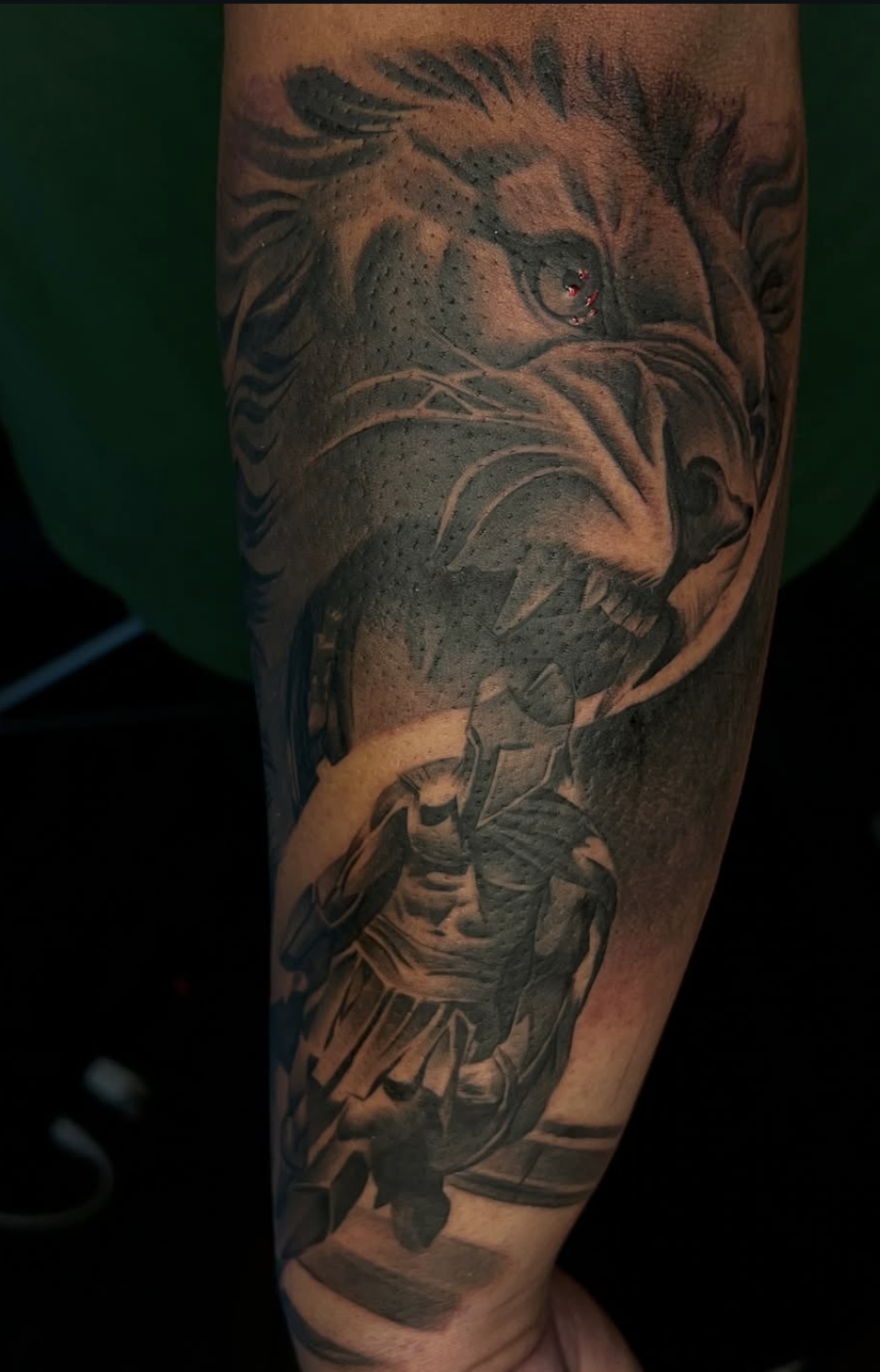 Black and grey eagle and warrior forearm tattoo by Martinez Placaz